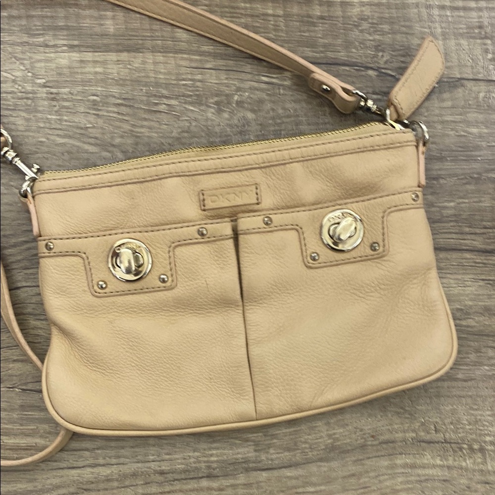 DKNY Tan Crossbody Bag with Zipper Closure and Decorative Metal Elements